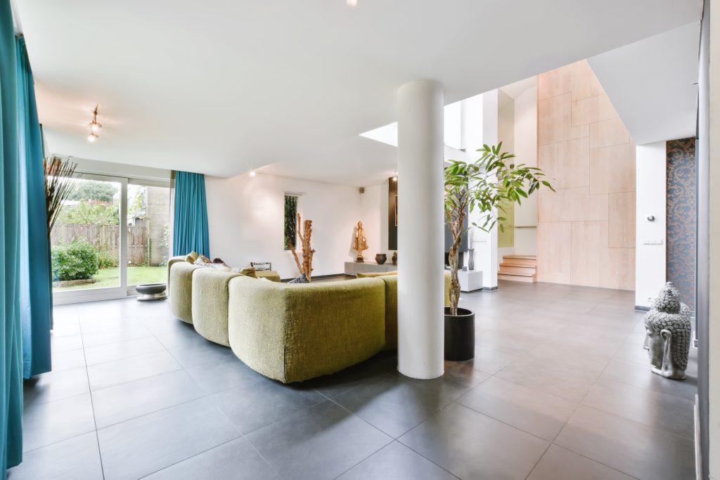 Cozy large living room with a yellow sofa in daylight