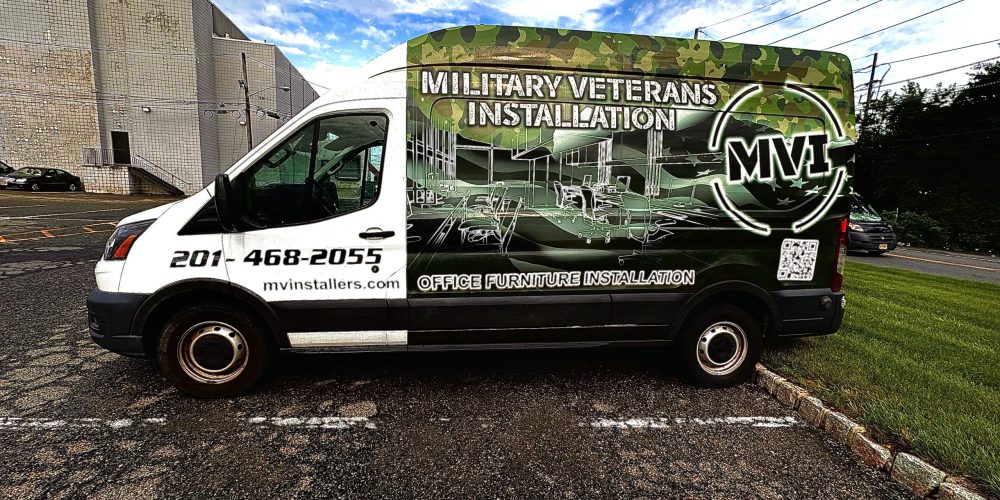 A military-themed van displaying "Military Veterans Installation" and services for office furniture installation, parked outdoors.